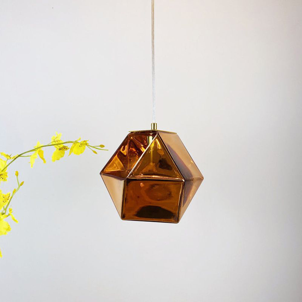 Hailie Rose Gold angular glass pendant beside yellow flowers
