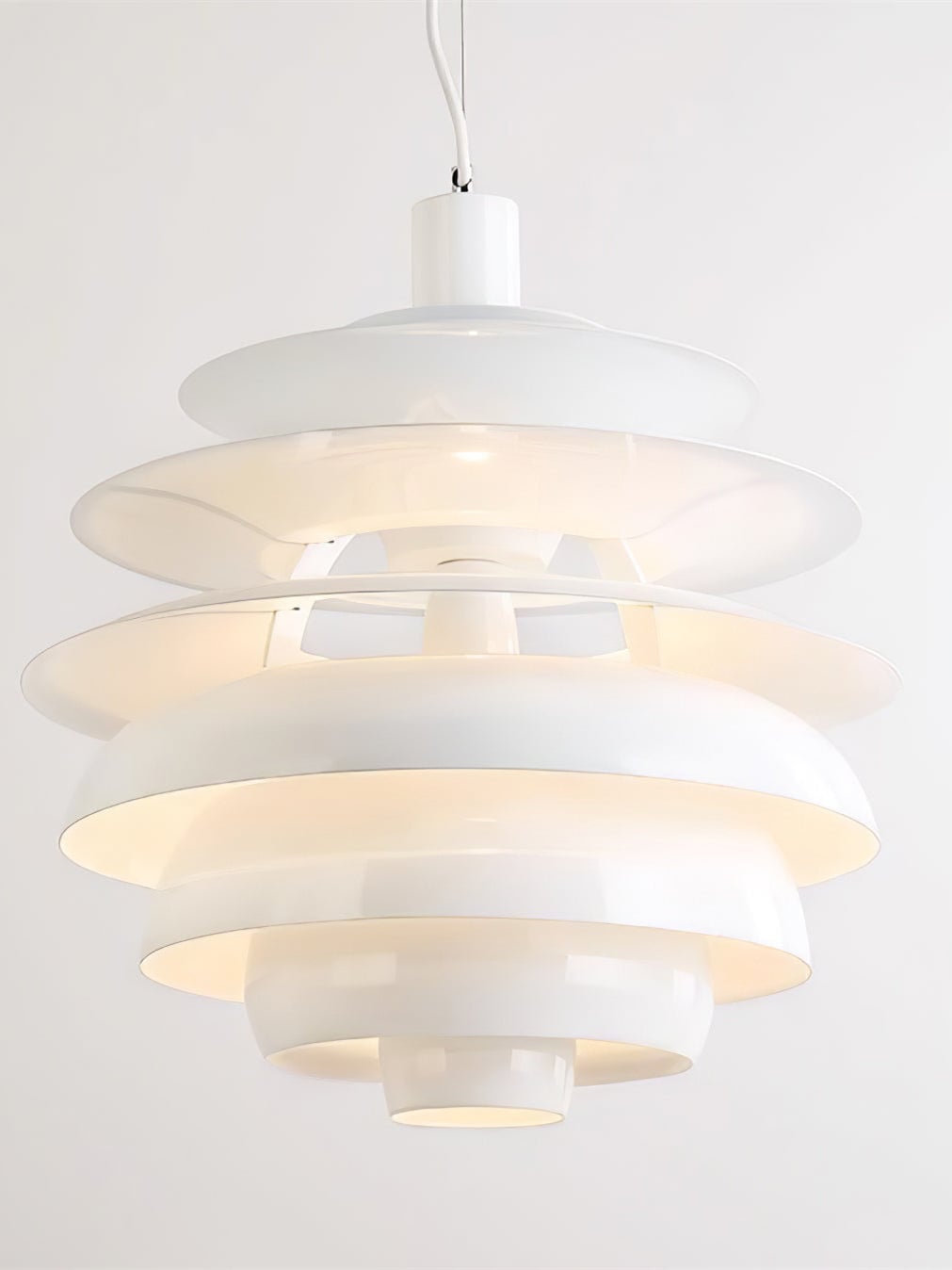 Close view of the illuminated stacked shade tiers on the Snowball pendant