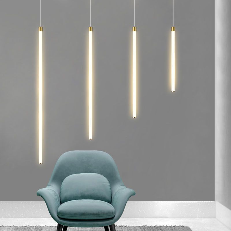 Four Edge vertical pendants of different lengths above a blue armchair