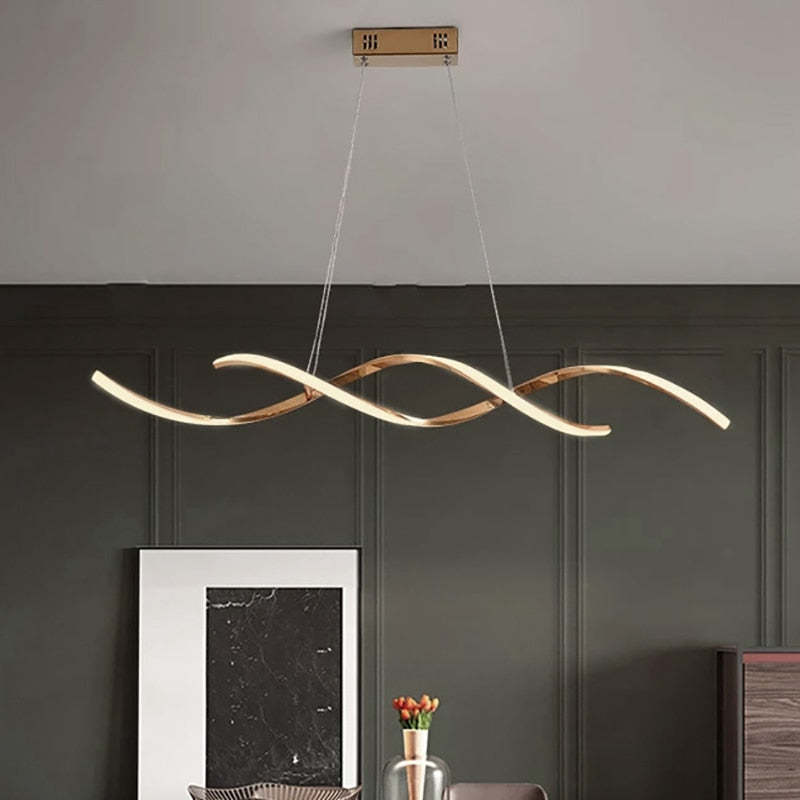 Gold Louise pendant above a table against a dark wall
