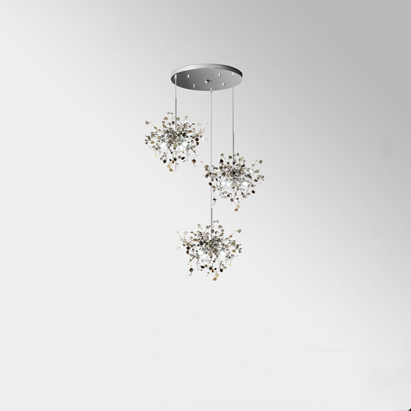 Silver staggered three-cluster pendant below round canopy