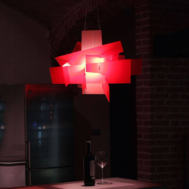 Renée red pendant glowing above a bar table against a dark wall