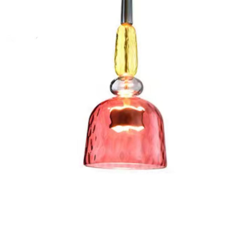 Red glass bell pendant below yellow upper ornament