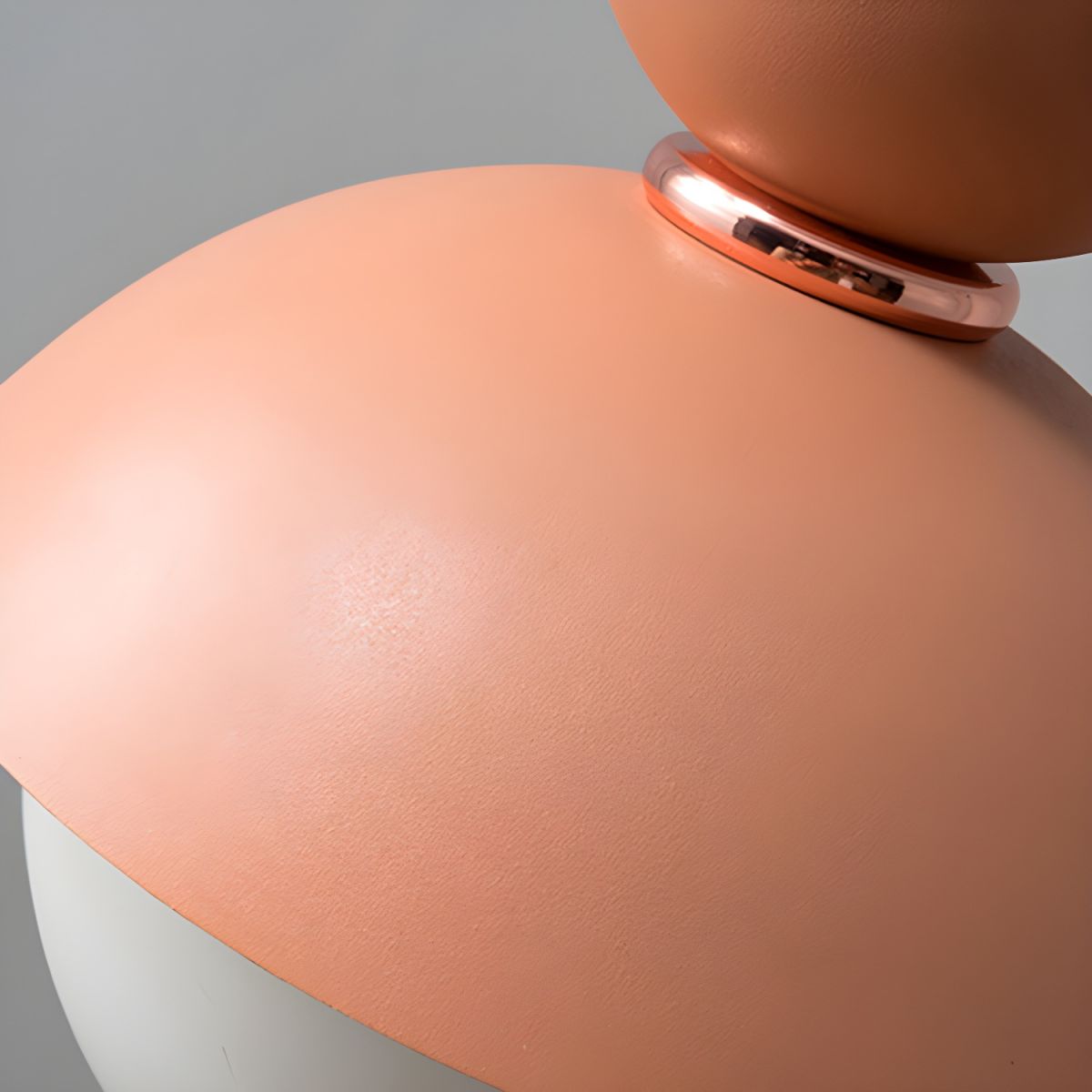Close view of pink metal shade and connecting ring