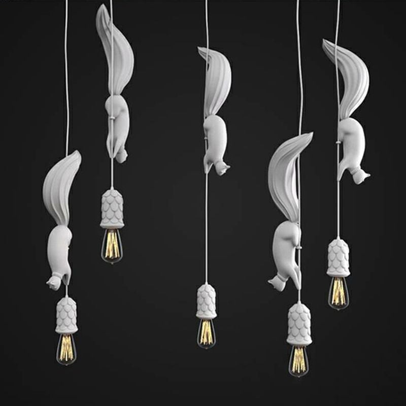 Five white squirrel pendants at different positions along cords, with pinecone-pattern holders and long exposed bulbs