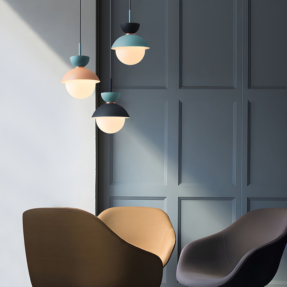 Blue and neutral globe pendants by dark wall