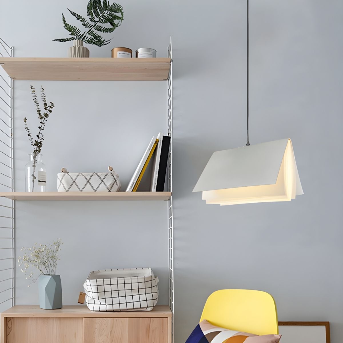 White book pendant beside shelves and chair