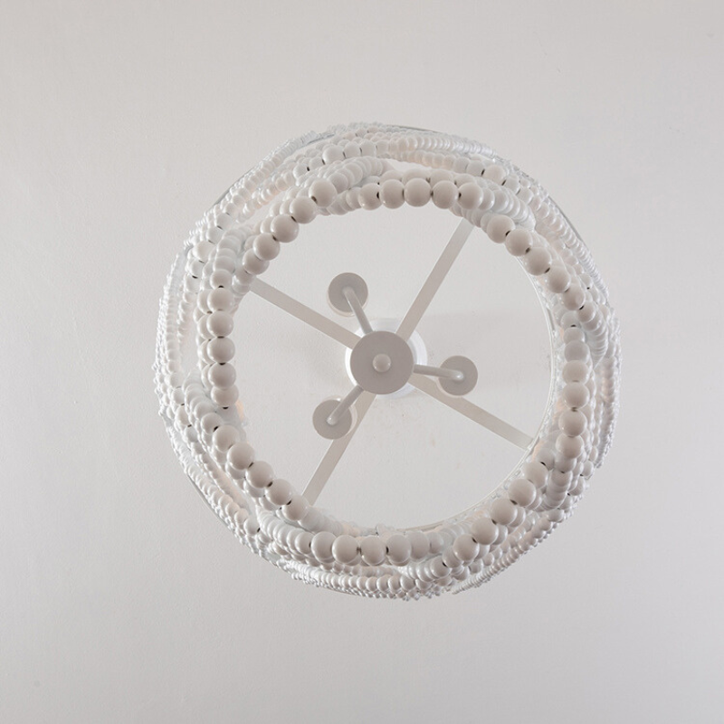 Underside of white beaded pendant with circular lamp-holder forms