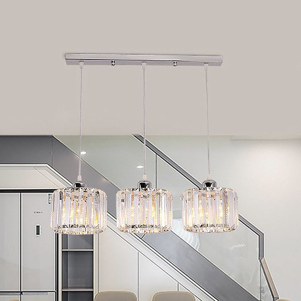 Three clear crystal column pendants above dining table