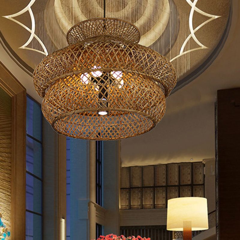 Close view of the lit Ritta layered rattan shade and open lattice weave.