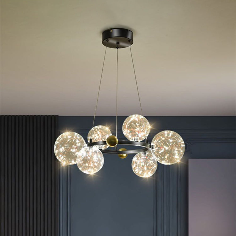 Compact black ring chandelier against dark blue wall