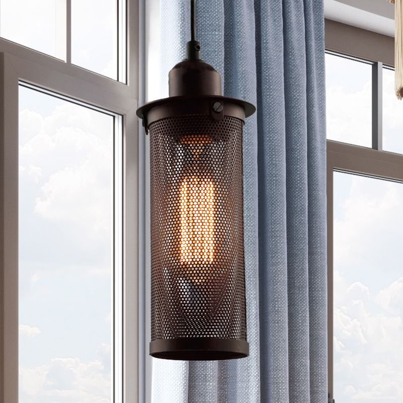 Sanna perforated cylinder pendant beside blue curtains