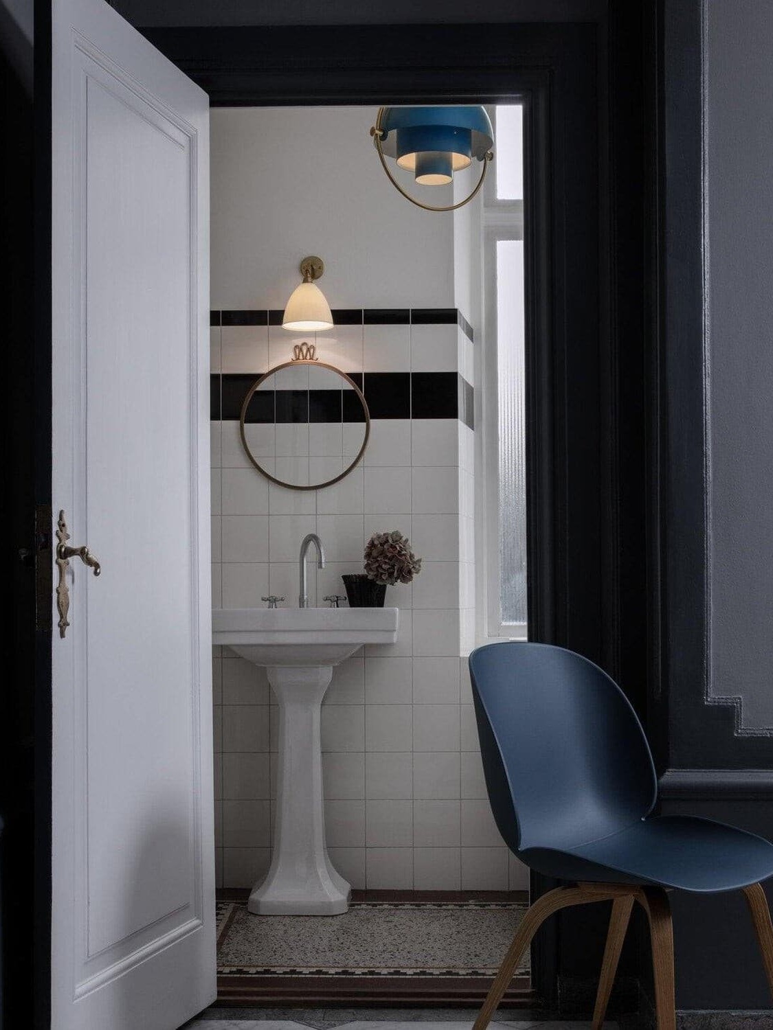 Black dome pendant shown near an interior washbasin