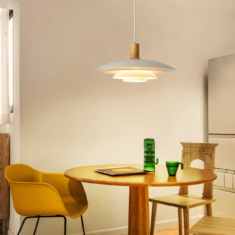 A-Wood pendant lit above round table