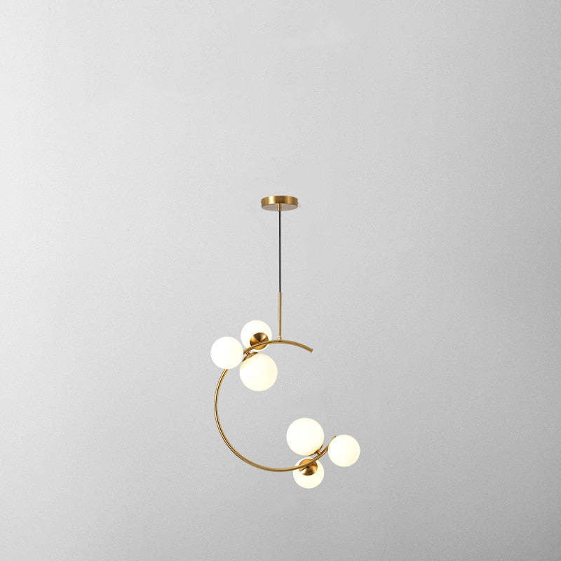 Isolated six-white-globe crescent pendant with a black cord and gold-tone fittings