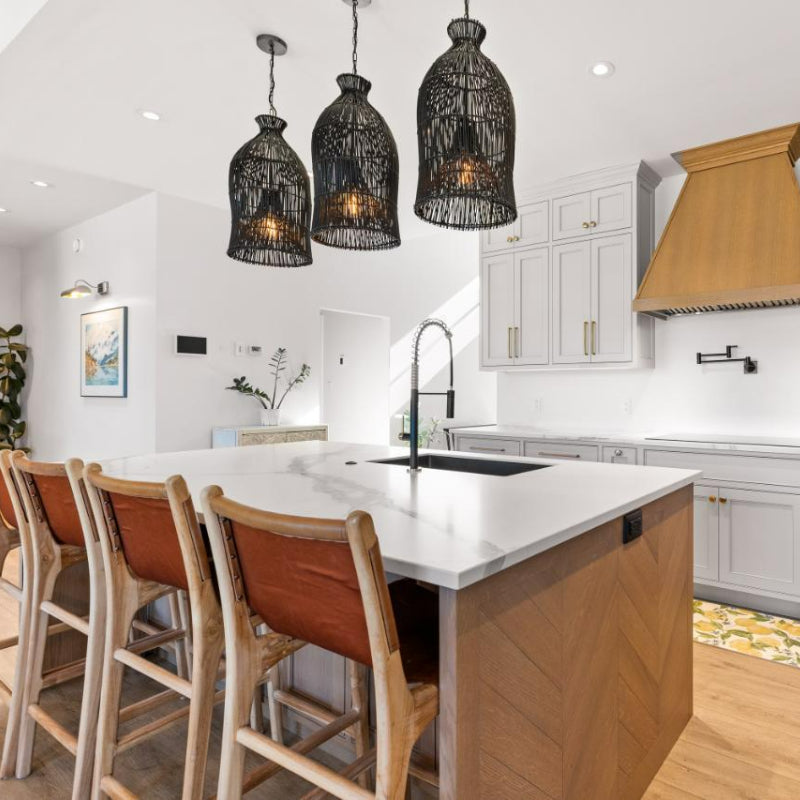 Three black woven pendants above a kitchen island