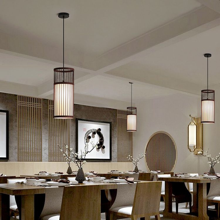 Coffee Ozawa cylinder pendants spaced above a long dining table