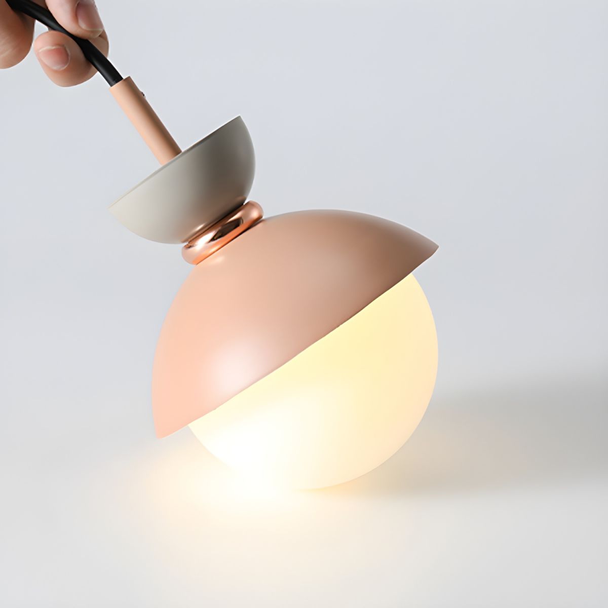 Pink-and-gray pendant held by suspension cord
