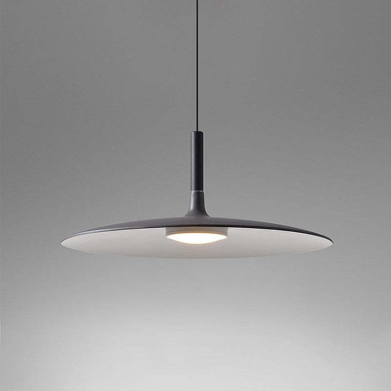Dark disc pendant with black upper neck, pale underside and central light against a gray background