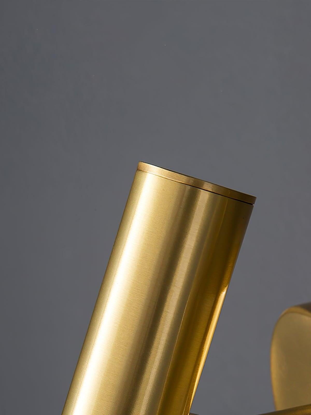 Close-up of the brass-coloured cylindrical light head and its capped upper end