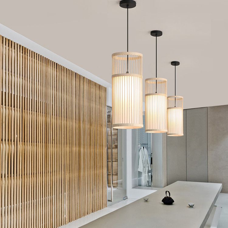 Three Wood-colour Ozawa cylinder pendants over a pale counter