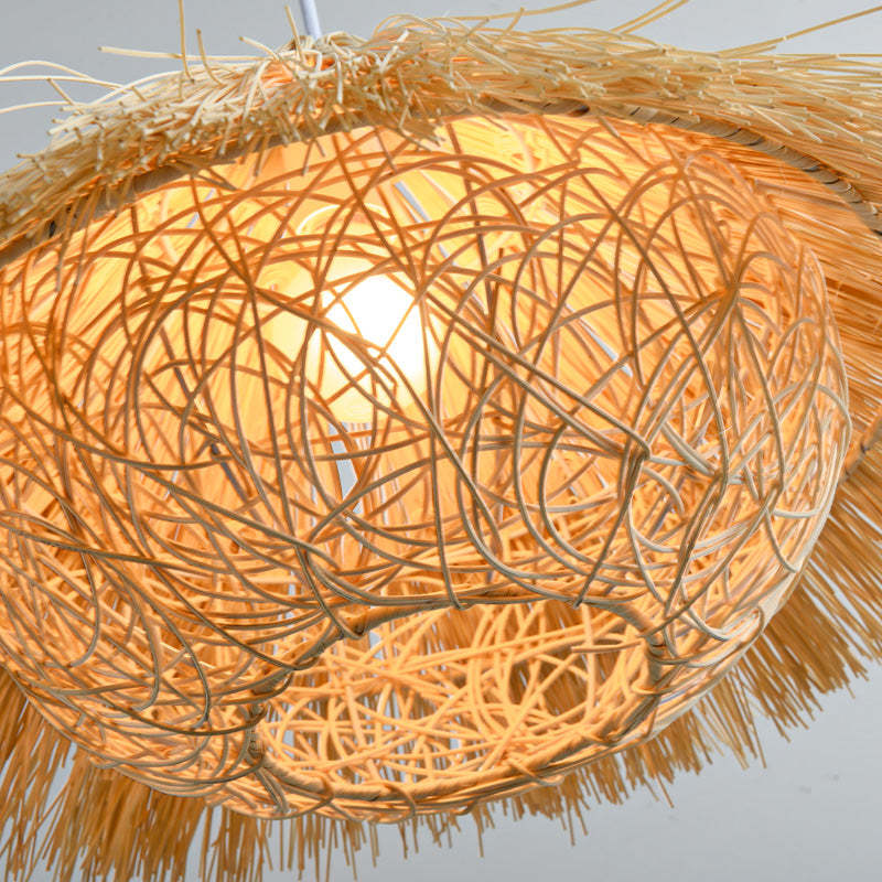 Close underside view of the Muto interwoven rattan strands and fringed rim.