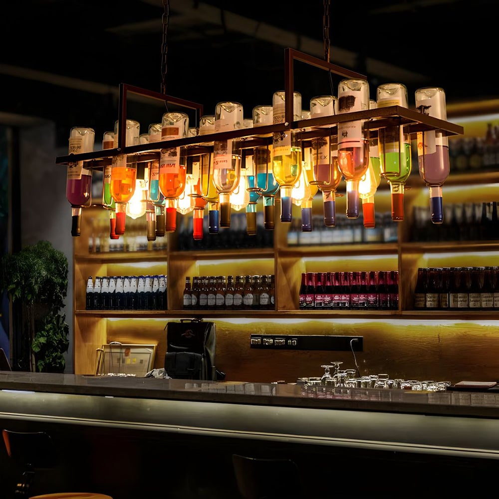 Long Hailie bottle pendant illuminated above a bar counter.