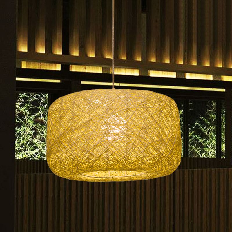Golden yellow cylindrical rattan pendant in timber-lined room