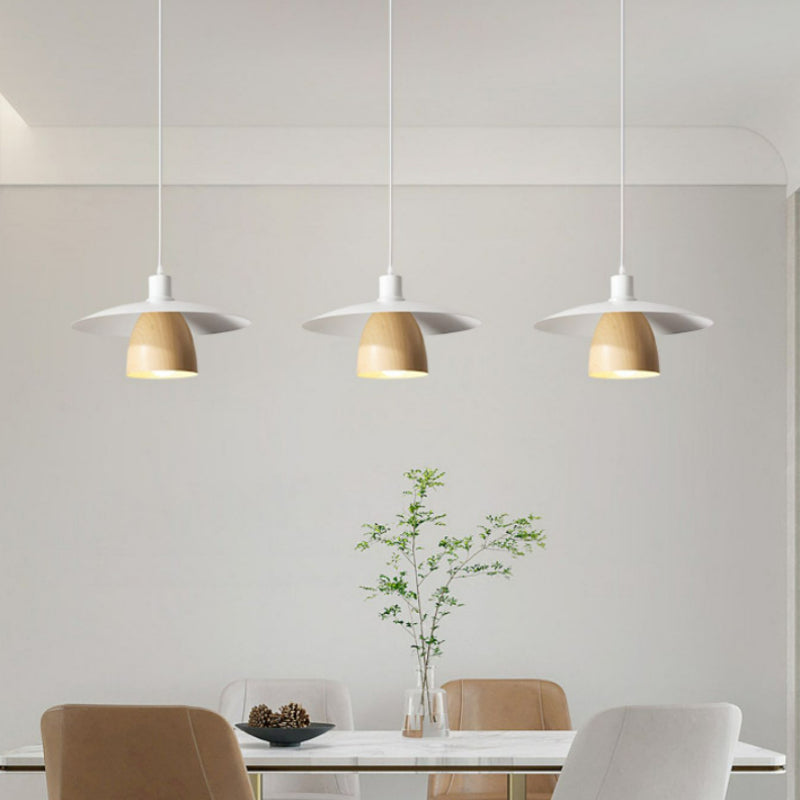 Three D white disc and wood-look cone pendants above dining table