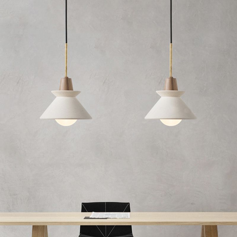 Two white Ozawa pendants hanging above a table.