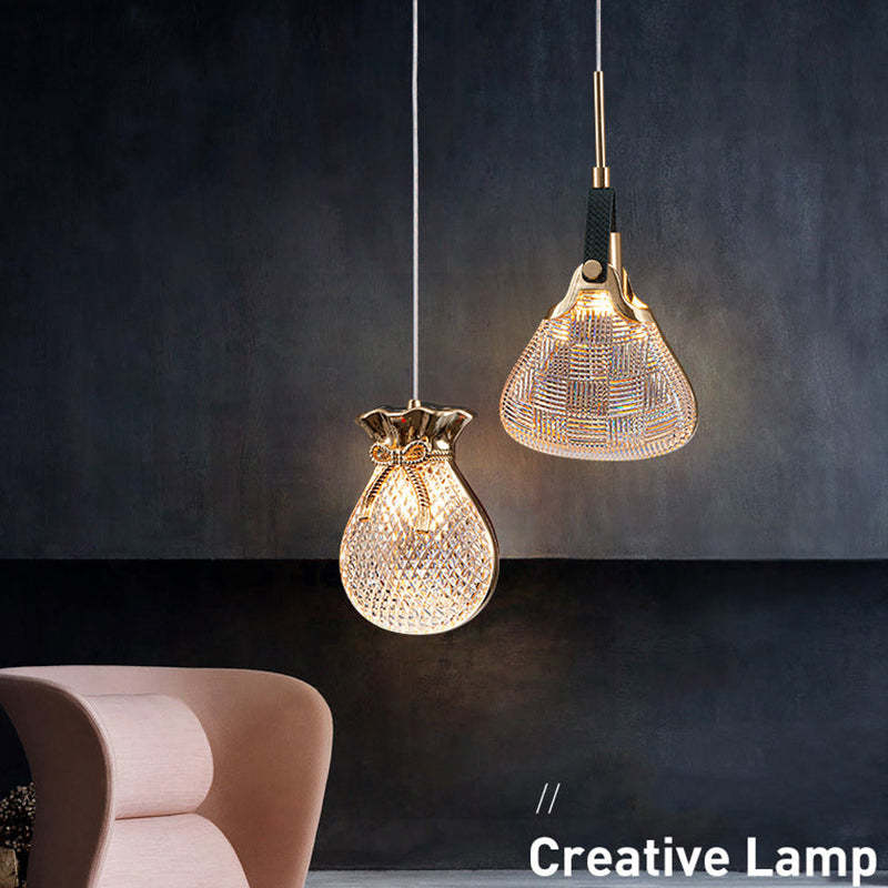 Pouch-shaped and flared Hailie shades glowing against a dark wall.