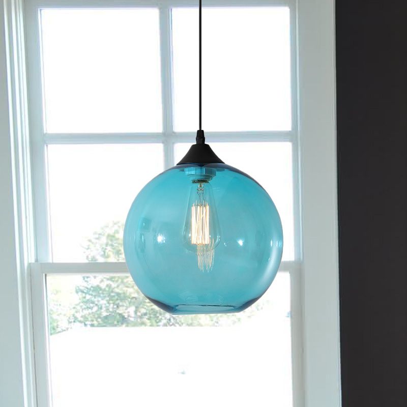 Sky Blue glass globe pendant beside a window