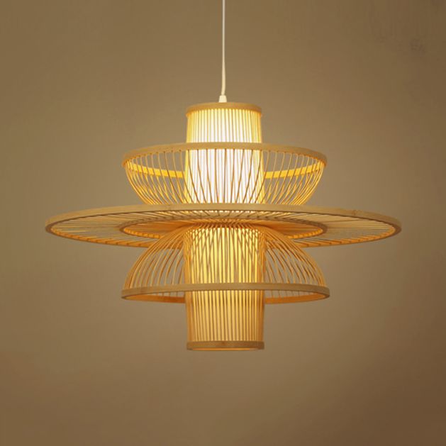 Muto beige lotus pendant glowing against a warm-coloured wall