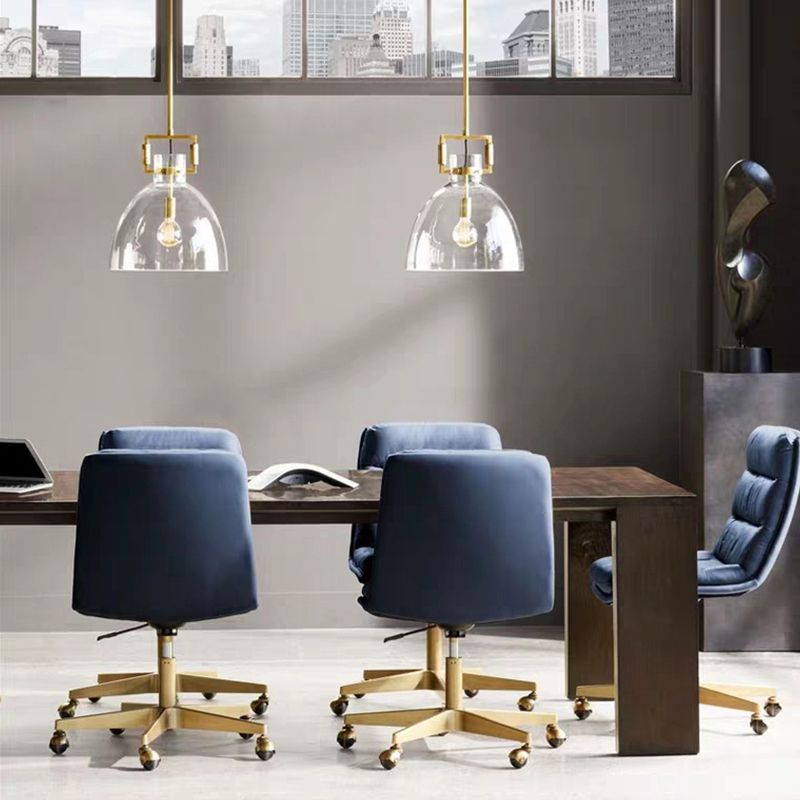 Two Cairns clear glass dome pendants above a long table with blue office chairs and city-view windows