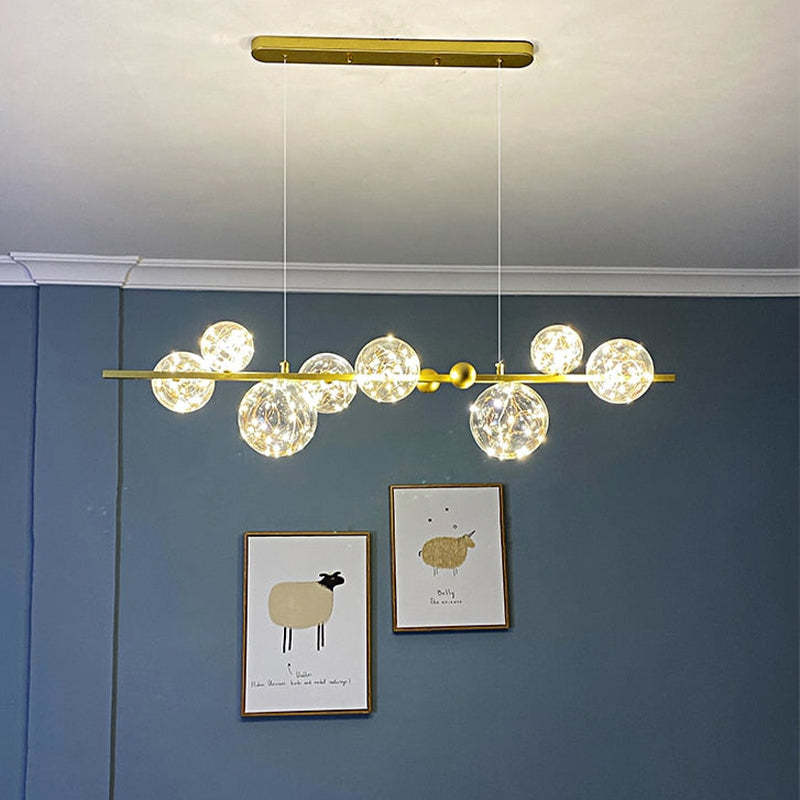 Gold linear glass-globe bar against blue wall