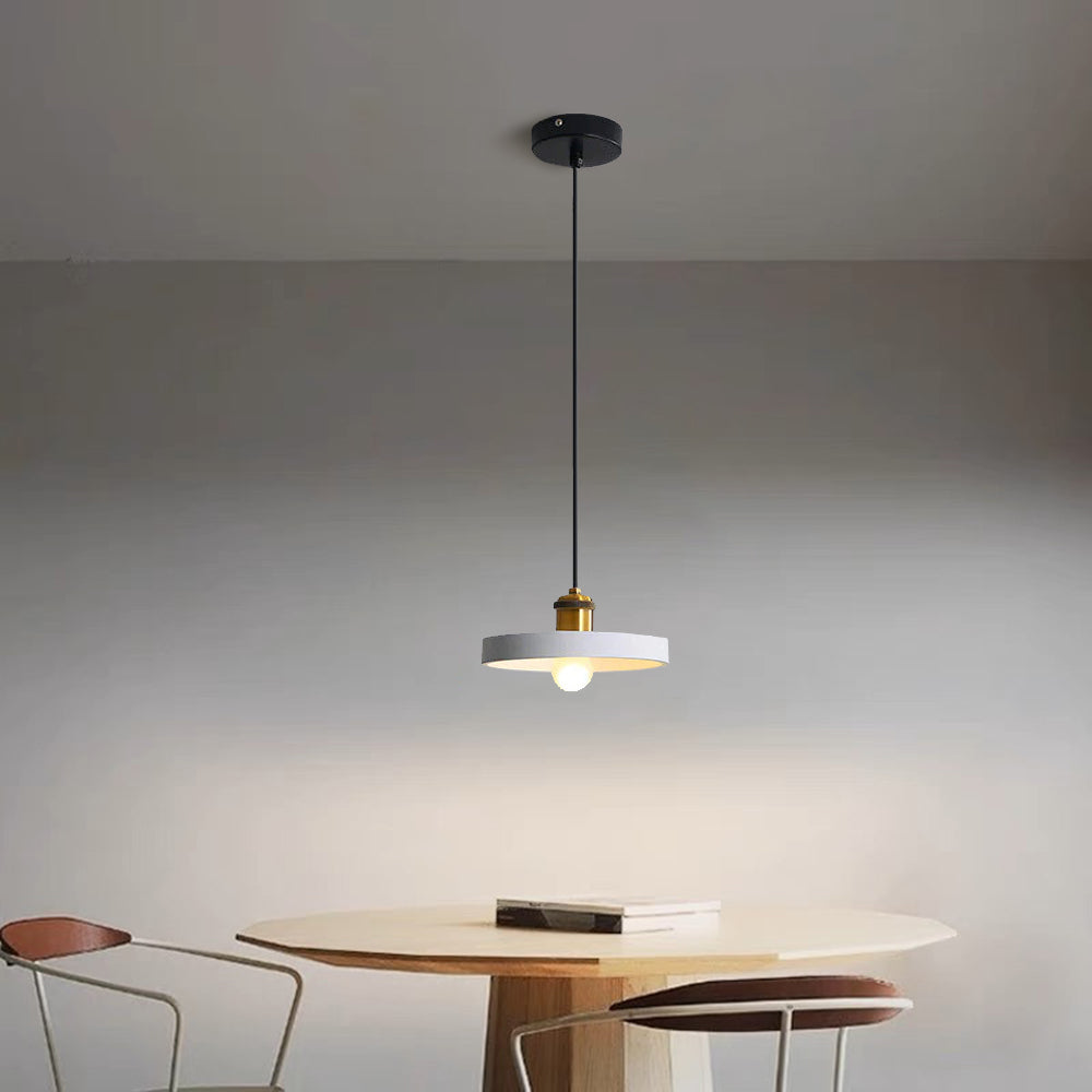 Light-coloured Morandi disc pendant above a round table.