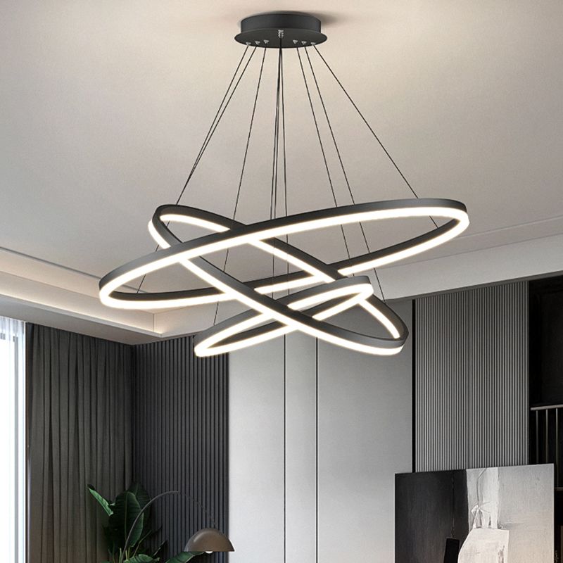 Three illuminated black Arisha rings in a dark interior