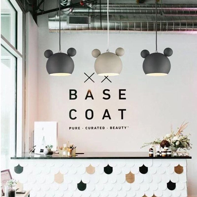 Black, white and black Morandi round-ear pendants over an indoor counter beneath wall lettering