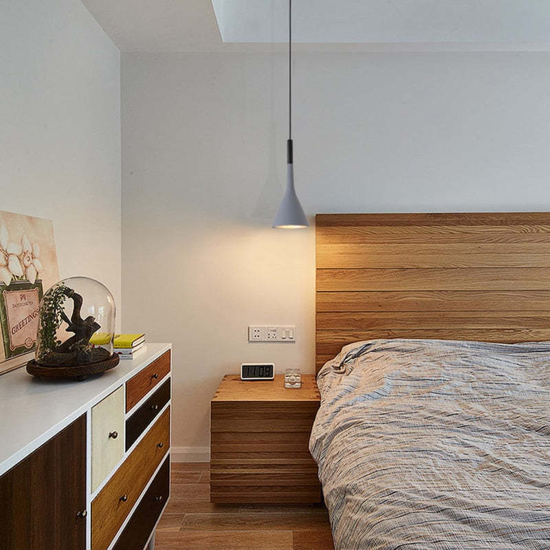 Gray metal cone pendant by bedside