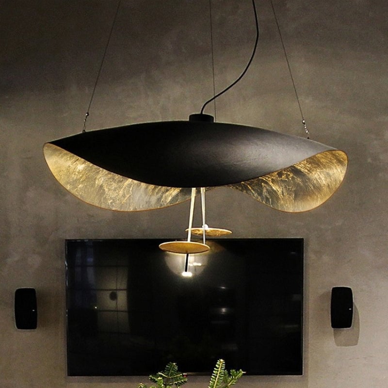 Lit Renée pendant showing textured gold-toned underside and illuminated lower disc