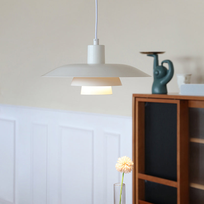 White layered A-style pendant near bright windows