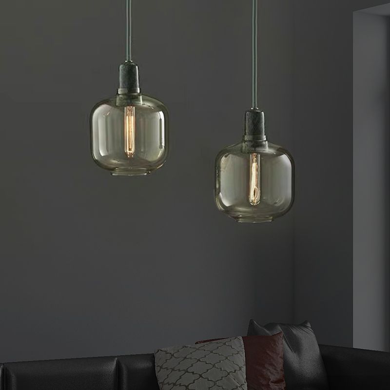 Short tinted-glass pendants in a dark living room