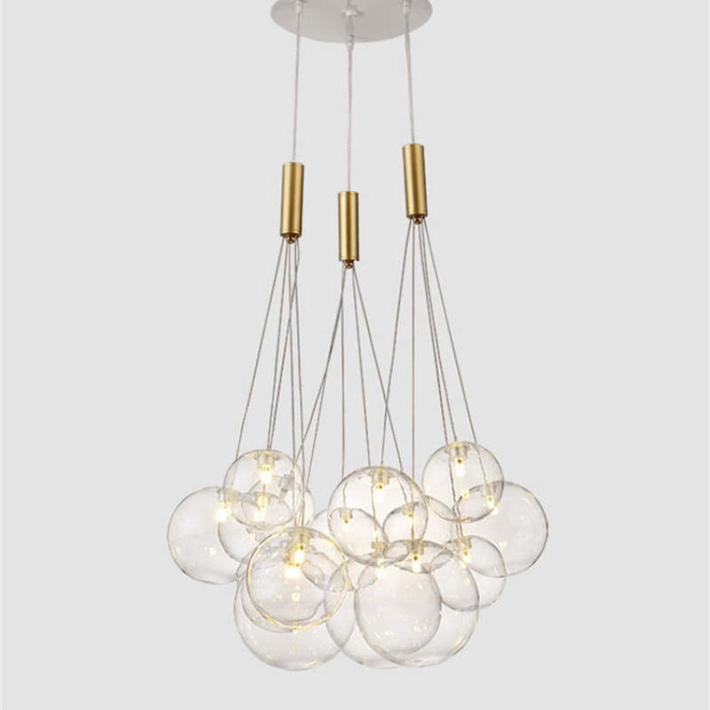 Isolated Valentina Transparent 15-bubble pendant with a white canopy, gold-tone fittings and clear globe cluster