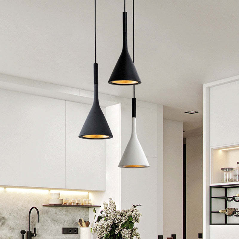 Black, white and gray cone pendants over kitchen