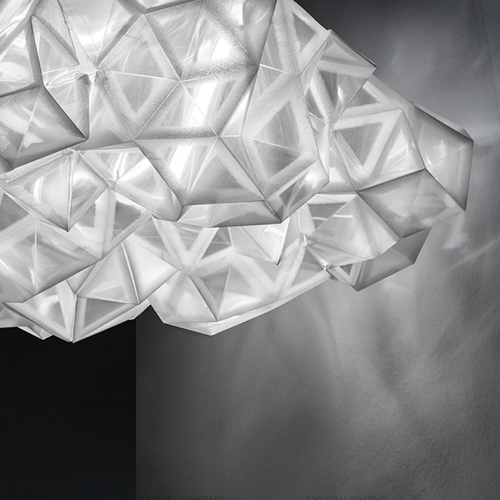Close-up of the angular edge of Bella translucent faceted shade beside a gray wall