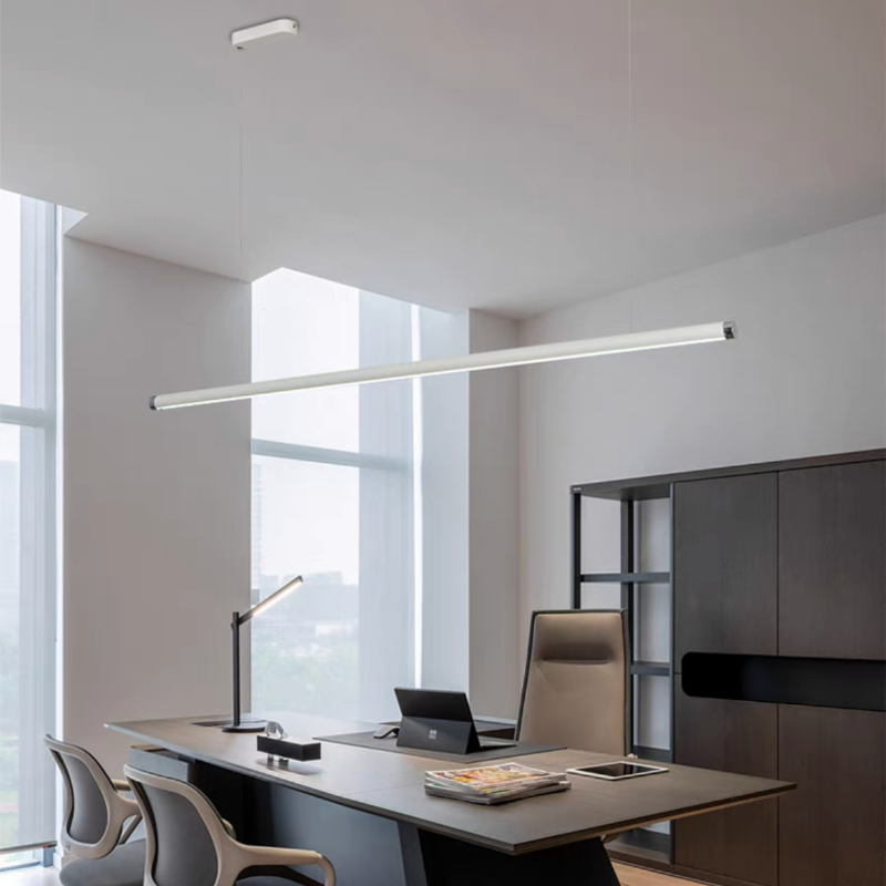 White-light tube pendant hanging above a dark dining table