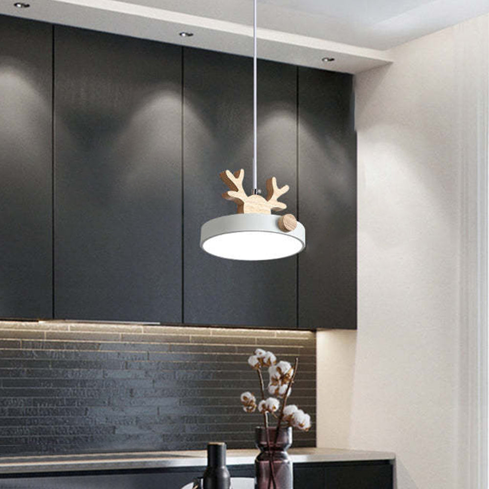 1 Head White option image, single pale deer disk pendant above counter before dark cabinets and cotton-stem vase