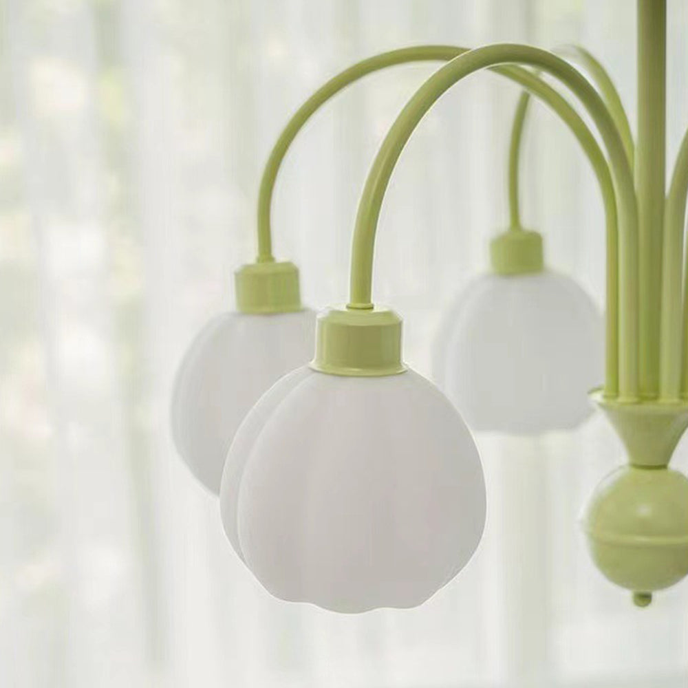 Close view of Lily white pumpkin-shaped glass shades on green curved arms