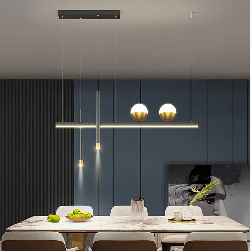 Illuminated Madina globe-and-bar pendant above a dining table.
