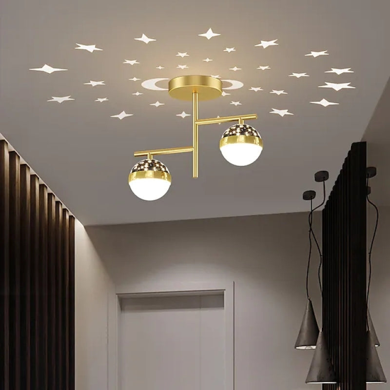 Gold A-style two-globe ceiling light over a corridor